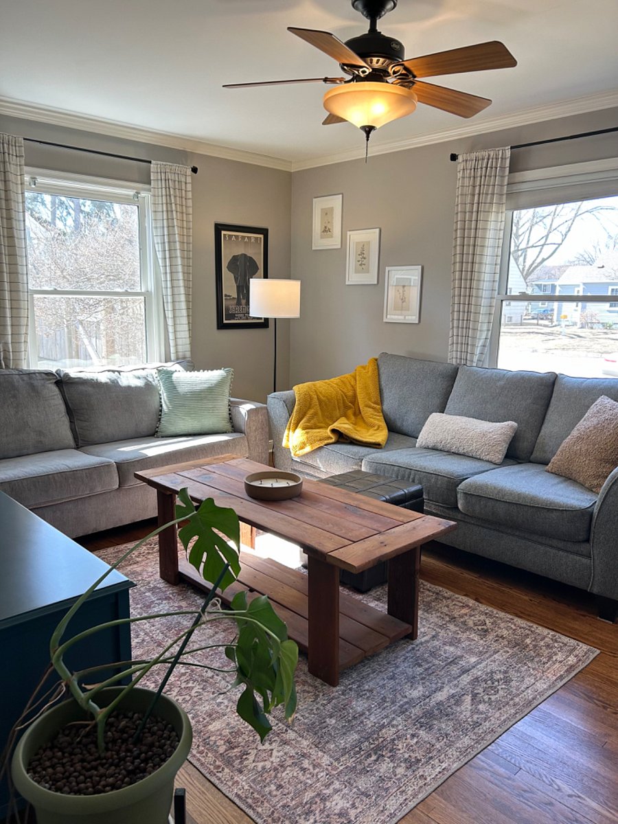 Cozy living room with two couches, ottoman and a coffee table.