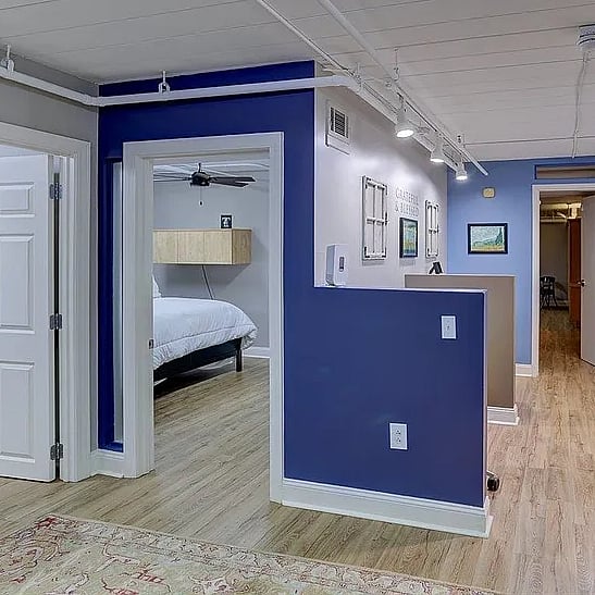 Hallway has 2 desk cubicles
