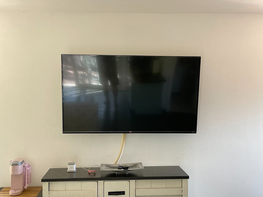 Wall mounted smart TV with high speed internet access and credenza to store your clothes