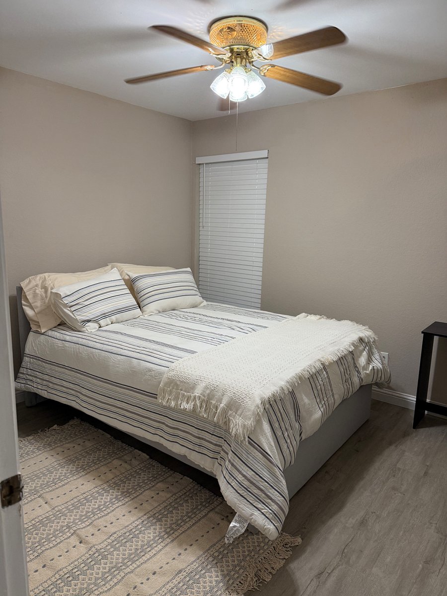 guest bedroom, night stand, rug, small desk, ceiling fan