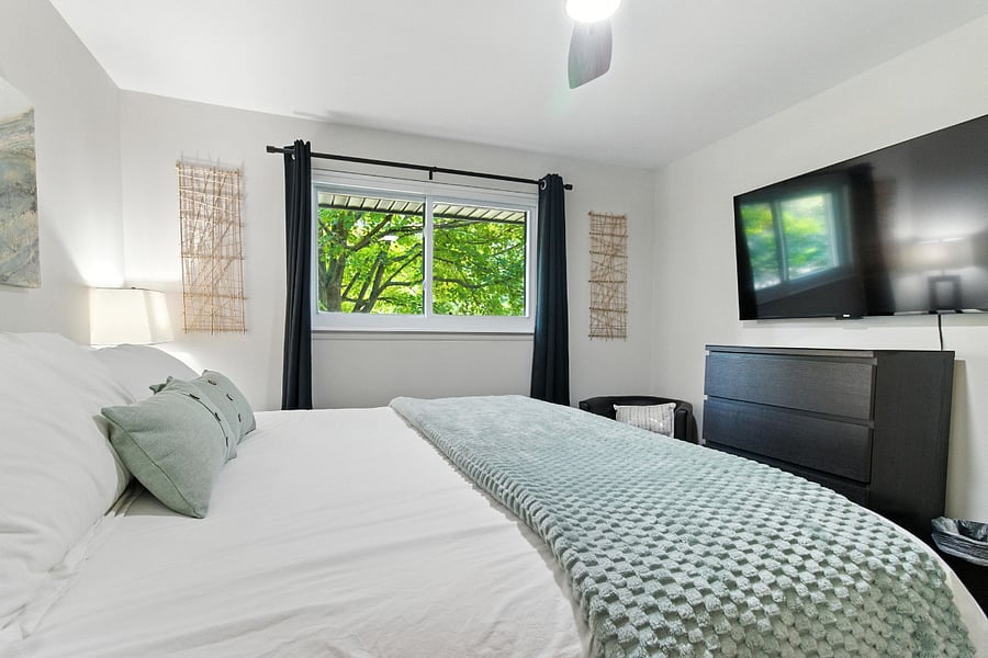 Bedroom 1 has a 55" Roku TV with a four-drawer dresser.