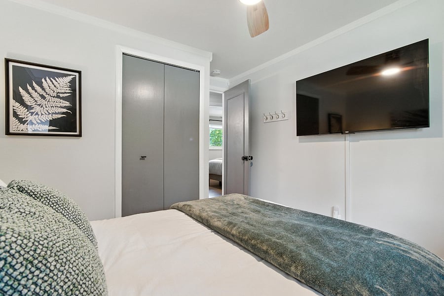 Bedroom 3 has a 50" Roku TV with a small 2 drawer dresser in the closet.