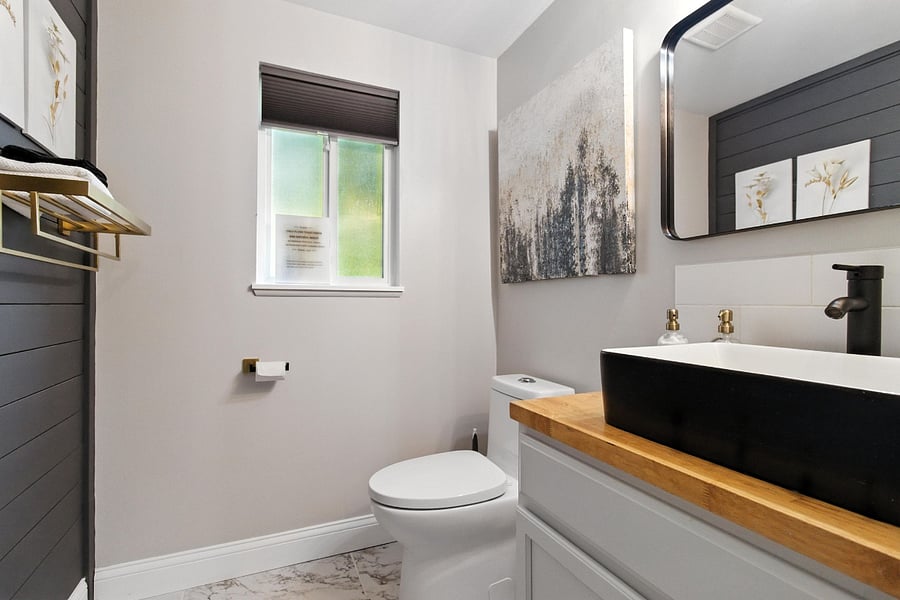 Half bath near the door to the garage and basement.