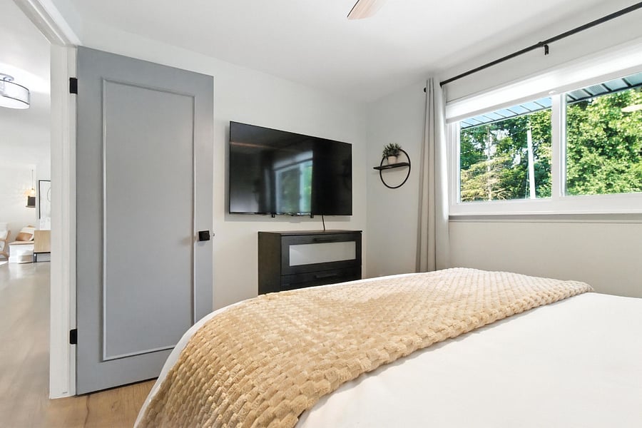 Bedroom 2 has a 55" Roku TV with a three-drawer dresser.