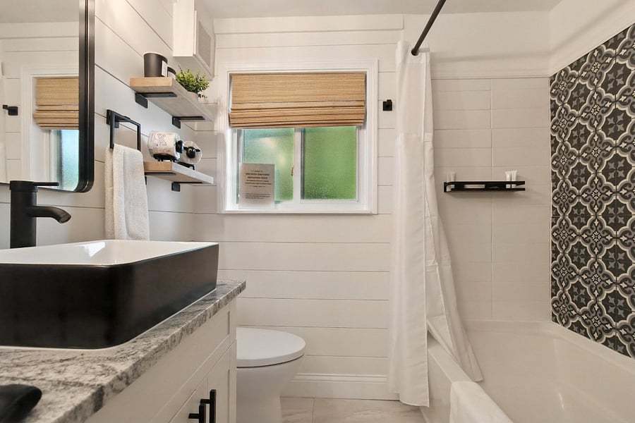 Full bath has a tub/shower combo with ceramic tile surround.