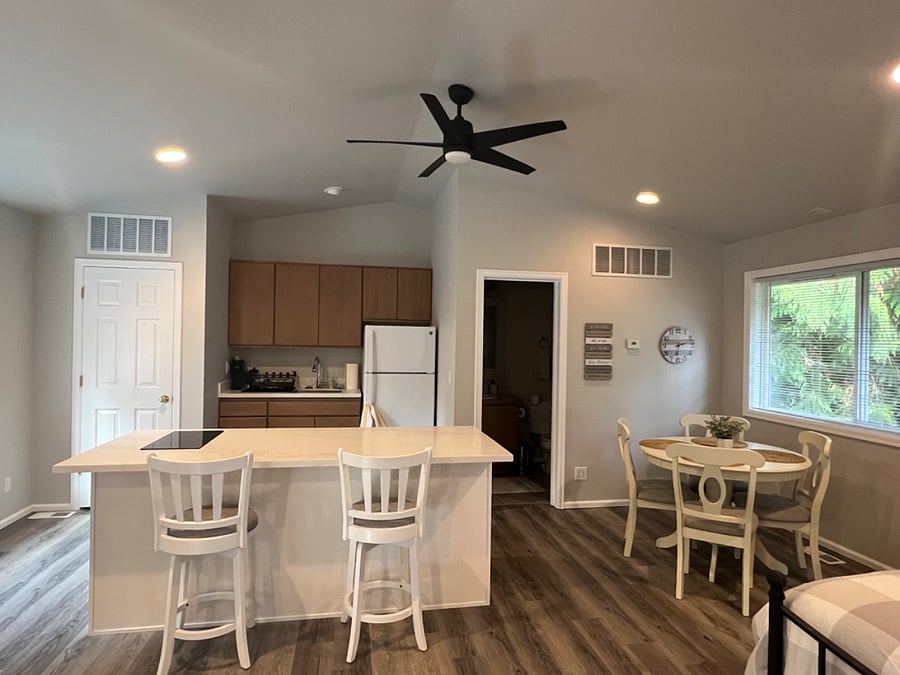 Kitchenette with all new appliances including induction stove top, combination microwave convection oven, full size fridge, washer and dryer.