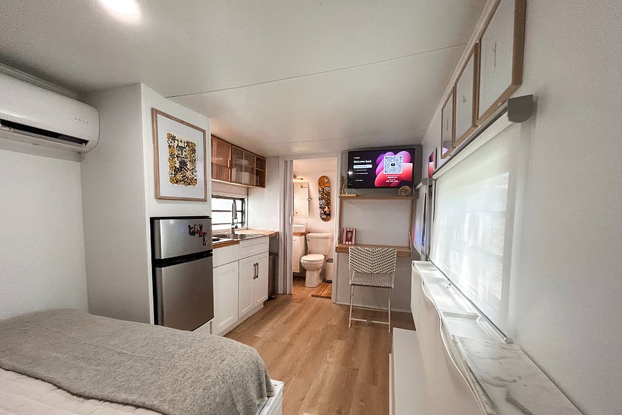 Kitchenette with 2-burner hotplate, microwave, and apartment fridge