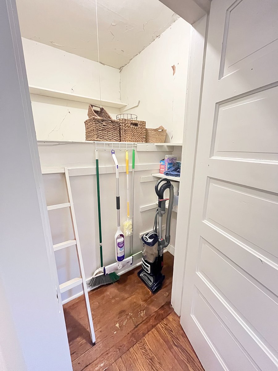 utility/storage closet with cleaning supplies and vacuum