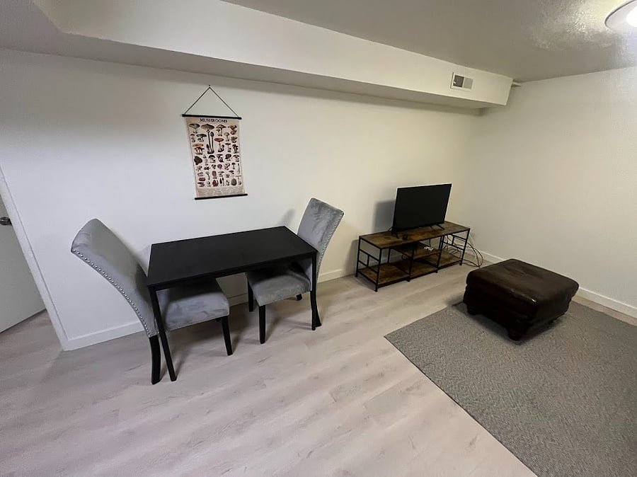 Dining area for 2. Family room offers a leather couch, smart tv and WiFi