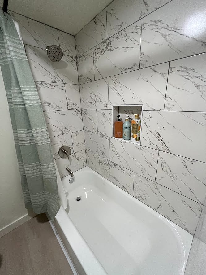Brand new shower with a full bathtub