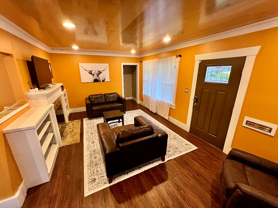 Shared furnished Living room with HDTV and leather club chairs and natuzzi sofa