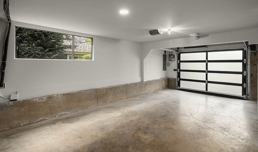 One Car Garage with max Car height of 70" (standard cars) allowed to park in Garage. There is a large driveway in which 2-3 cars can comfortably park as well.