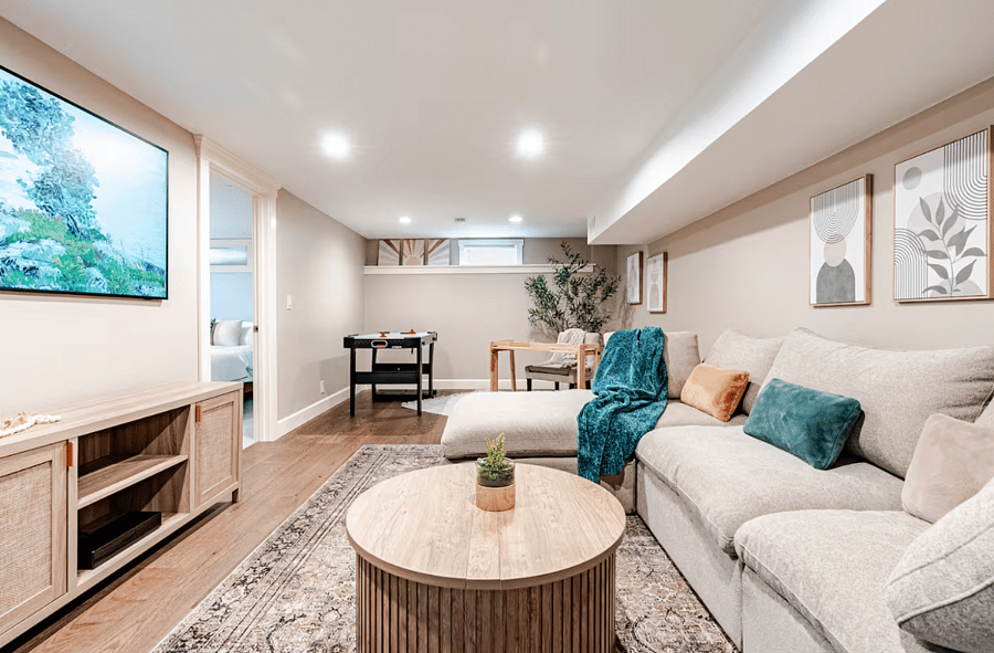 Cozy downstairs living area complete with an air hockey table and cozy couch and brand new Samsung Frame Smart TV