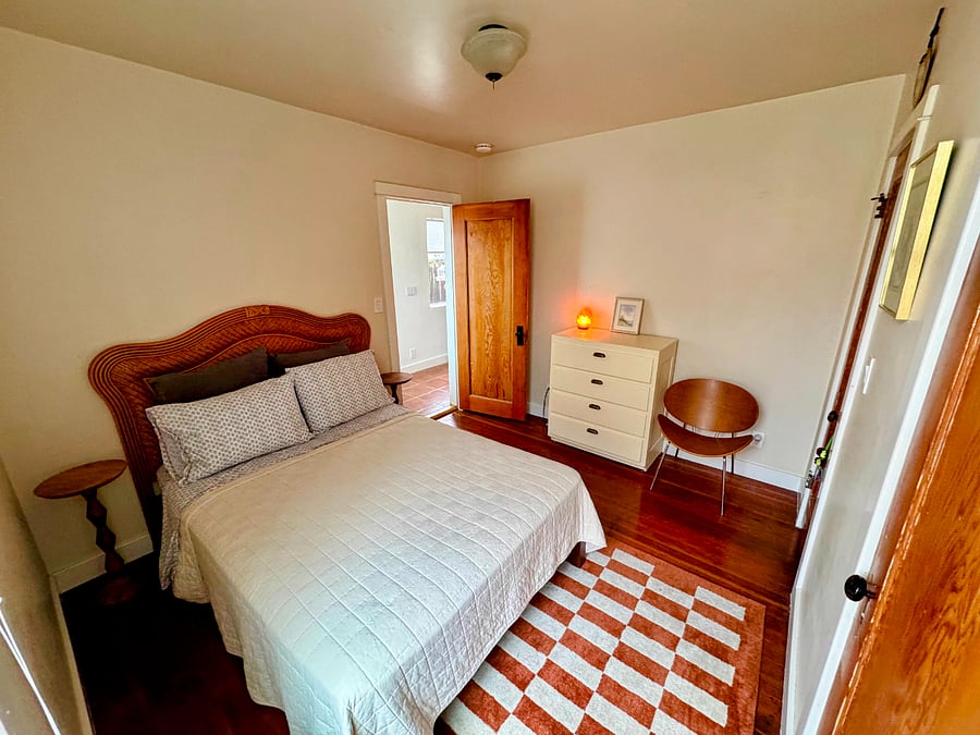 Bedroom with full bed, dresser, closet, and sunny window