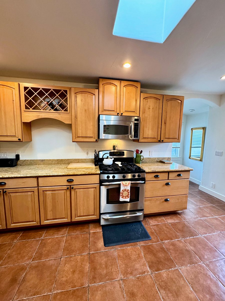 Gas stove, microwave, and fully stocked cupboards (pots, pans, cooking oil, spices, & more).