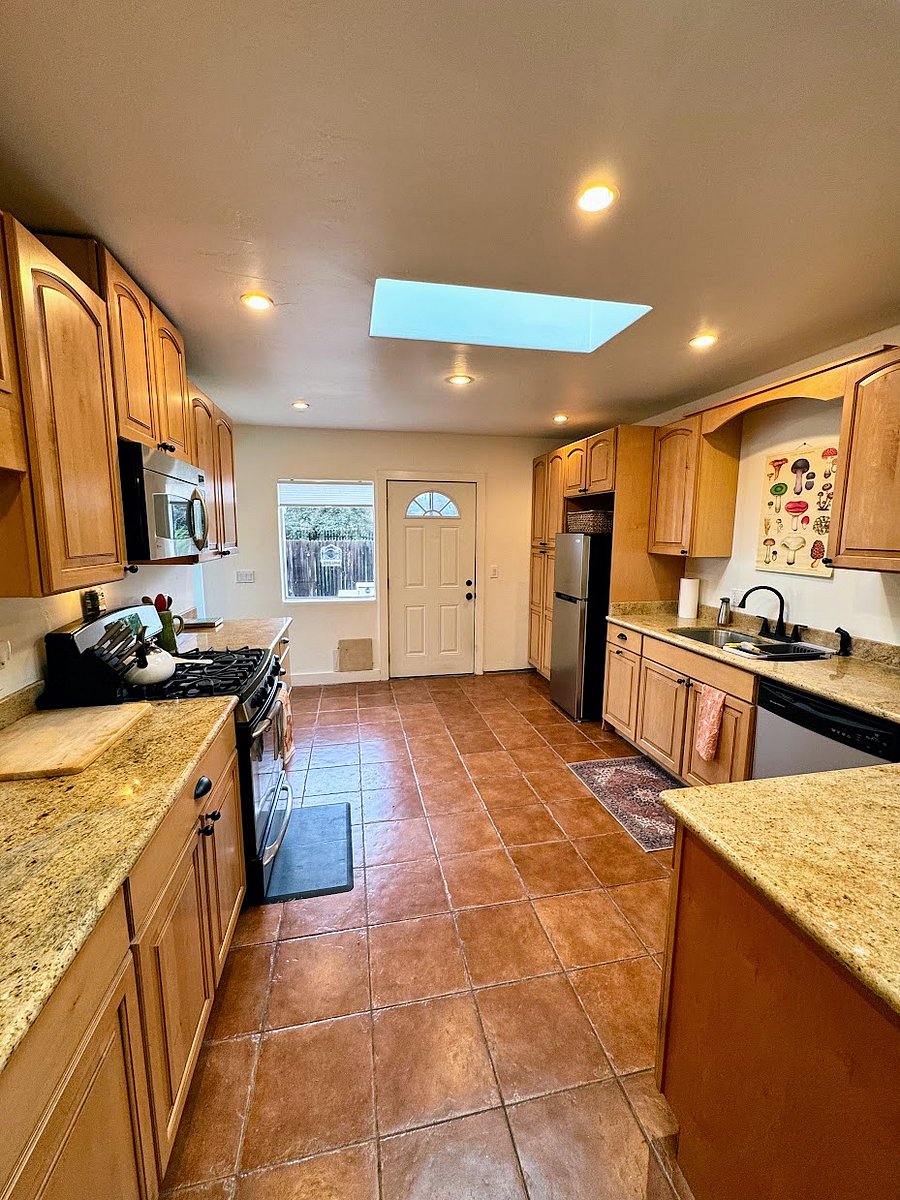 Huge kitchen with granite countertops.