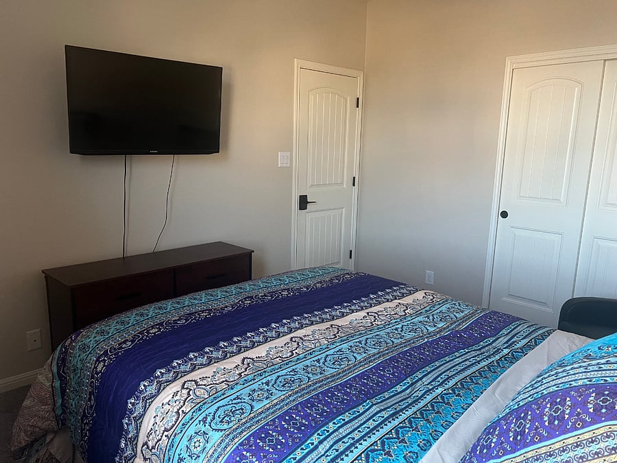 Boho-style private Bedroom with blackout curtains, tv, recliner