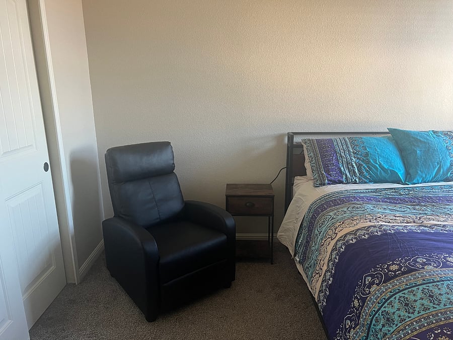 Boho-style private Bedroom with blackout curtains, tv, recliner