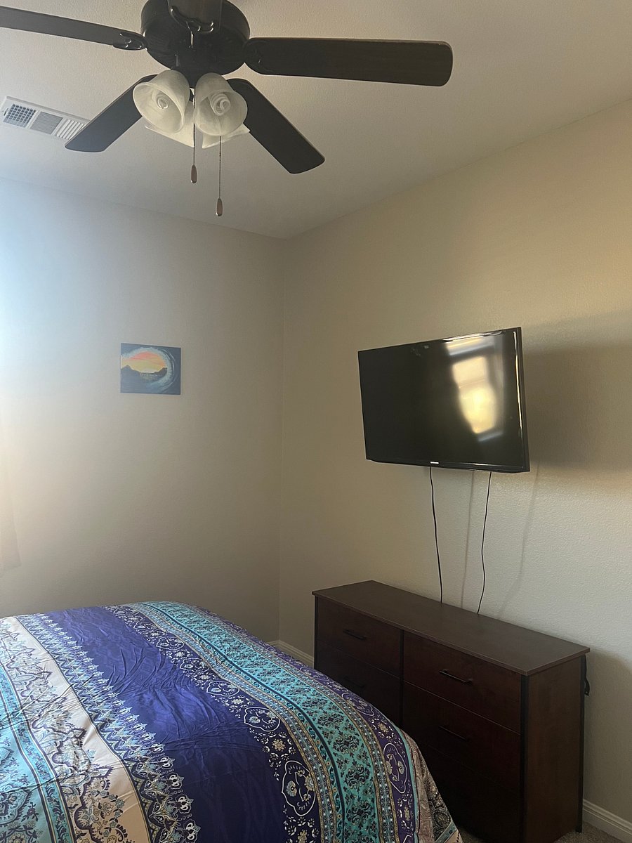 Boho-style private Bedroom with blackout curtains, tv, recliner