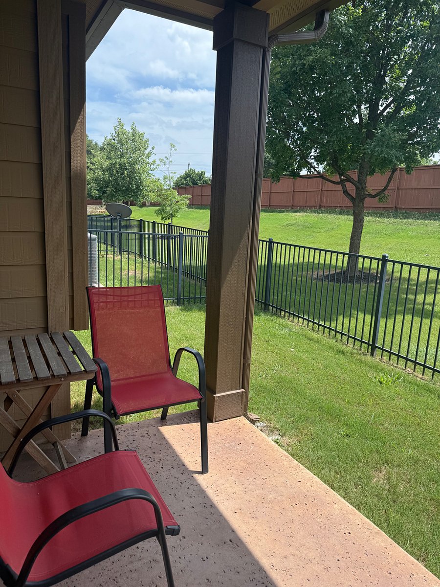 Shared outdoor, covered patio area with ceiling fan