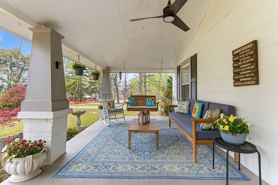 Inviting front porch with comfortable seating and swing.