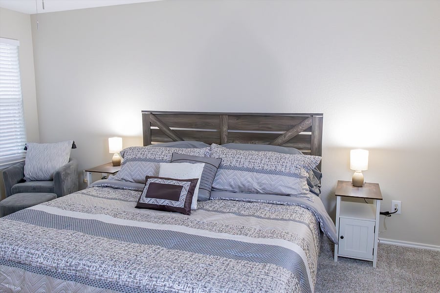 Master Bedroom Includes a Private Chair and Comfortable Pillow for Reading and Relaxation