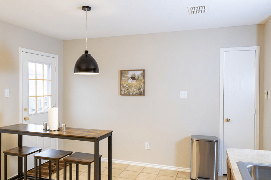 Kitchen Connects to a Spacious Backyard with an 8-foot Privacy Fence Providing Plenty of Room for Outdoor Activities and Play
