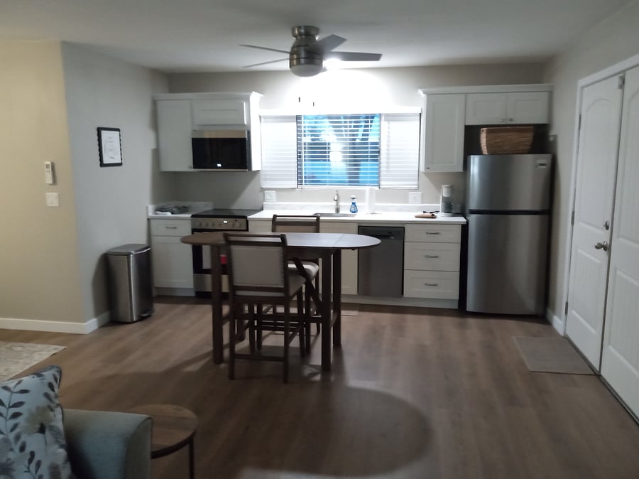 Kitchenette including full size refrigerator, small convection oven with range, microwave oven, dishwasher, garbage disposer, soft water and stocked with eating and cooking utensils. Window looks out to large backyard.