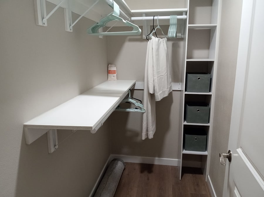 Walk-in closet , with two closet poles for shirts/blouses, skirts/pants and one short one for long dresses/coats. 6 cubby holes for storage of clothes, purses, shoes and two shelves above hanger racks.