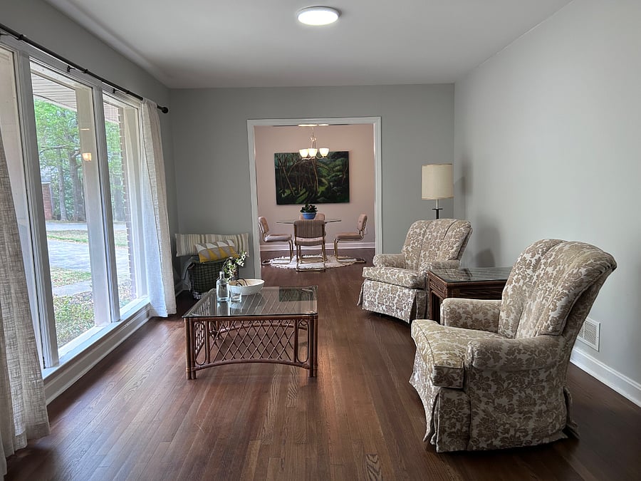 Living room with large windows that look out on front yard