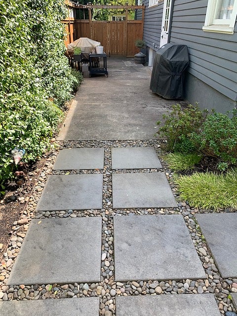 Side yard has a BBQ and outdoor table during summer and fall months.