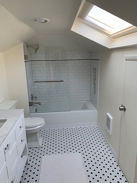 Skylight in remodeled bathroom opens and closes with remote. 