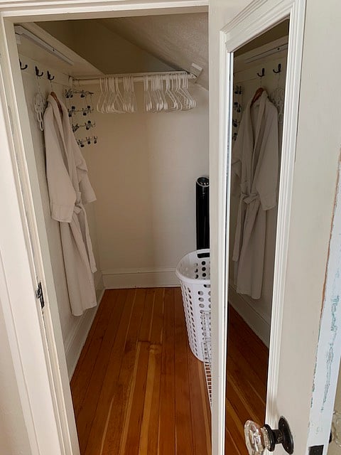 Bedroom closet has hamper, robe, and multiple fans to keep air temperatures comfortable. 