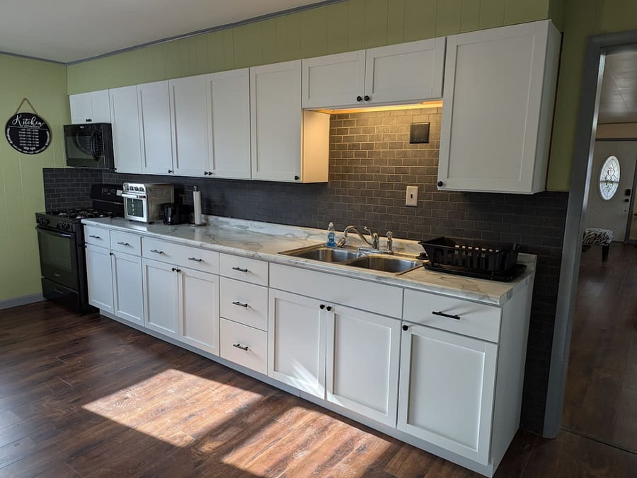 Kitchen counter, sink, and cabinets.