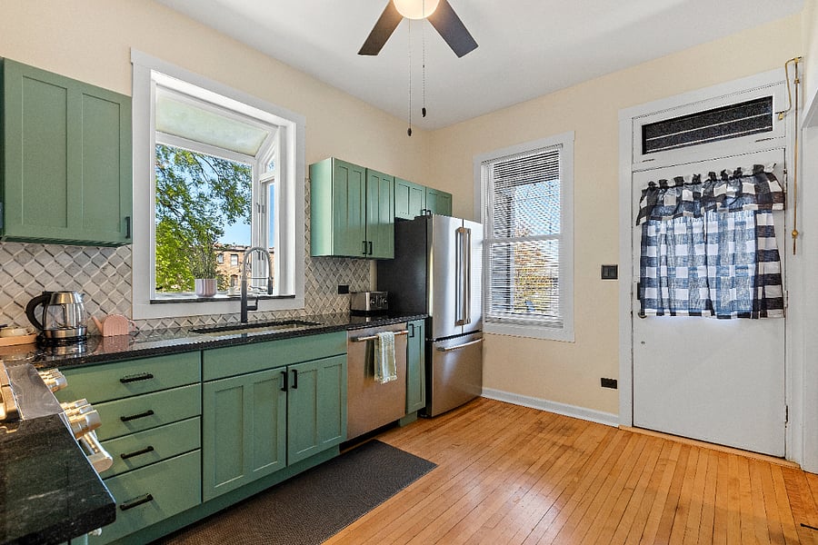 Step into a kitchen where warmth meets sophistication, featuring rich maple floors and cabinetry. Sleek chef-grade stainless steel appliances, gleaming granite countertops, and a stylish stone backsplash create a perfect blend of elegance and function. Fully stocked with all the essentials, this inviting space is ready to make you feel right at home.