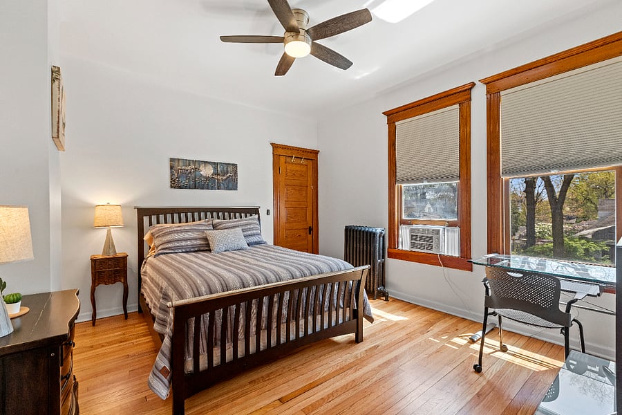 The primary bedroom offers a second convenient workstation, perfect for productivity or quiet reflection. All three bedrooms are thoughtfully designed with ceiling fans and room-darkening blinds, ensuring a comfortable, restful atmosphere at any time of day.