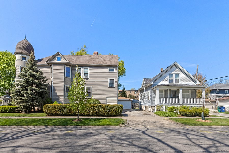 The off street driveway parking is behind the home along the coach house side.
