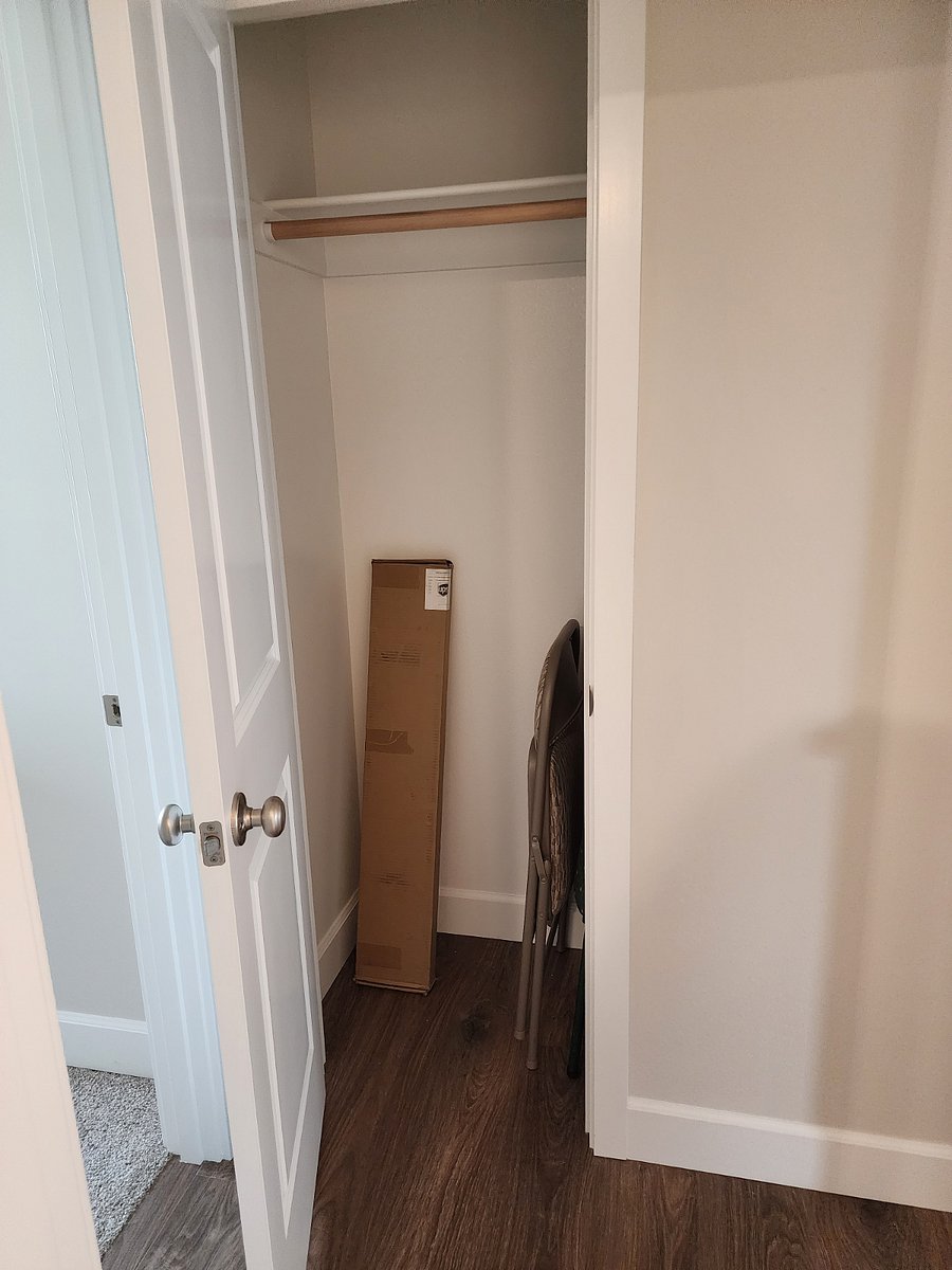 Coat closet in hallway before bedroom