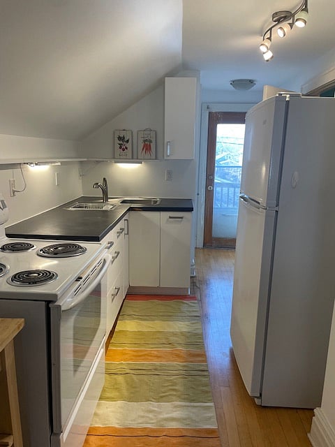 Adorable well lit kitchen. Private deck overlooking back yard out the glass door.
