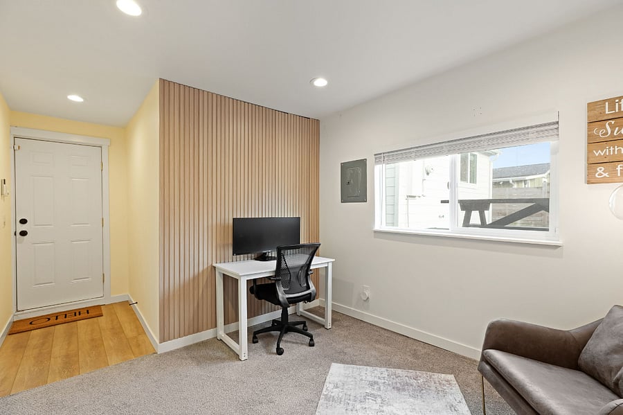Office space is private with a separate door and a wall separating it from garage.