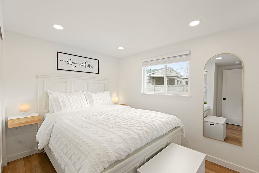 Primary bedroom includes a queen size bed and chest box to store linens and towels.
