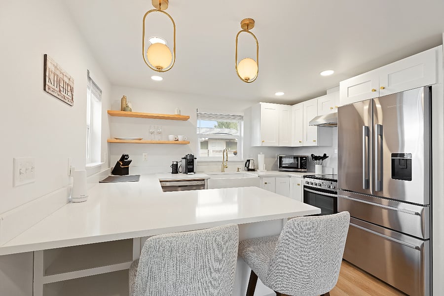 Remodeled kitchen with modern design and stainless-steel appliances.
