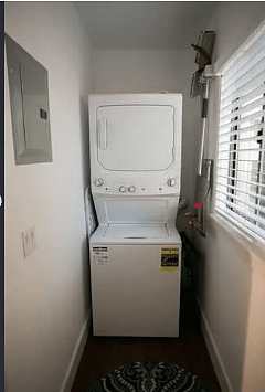 Washer and dryer and laundry room wit extra fridge and contertop