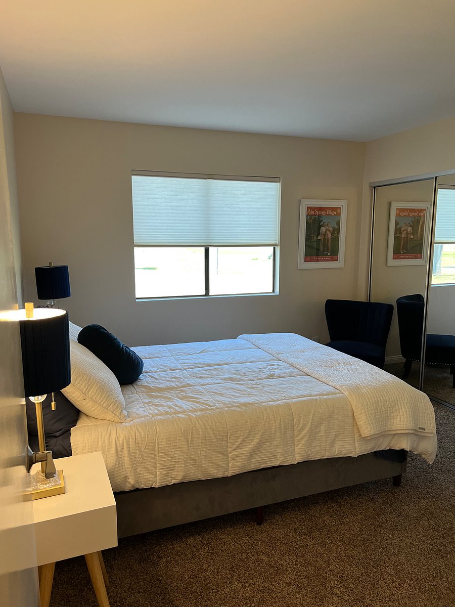Guest bedroom with queen size bed, TV and golf course view.
