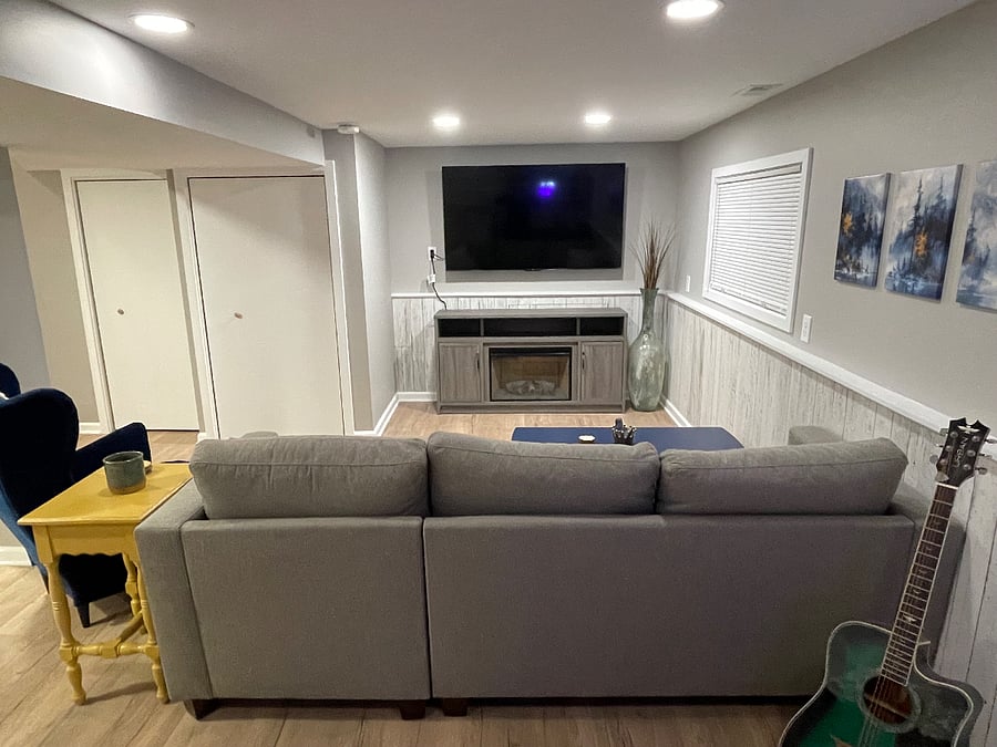 Downstairs tv room with 65" smart tv and electric fireplace