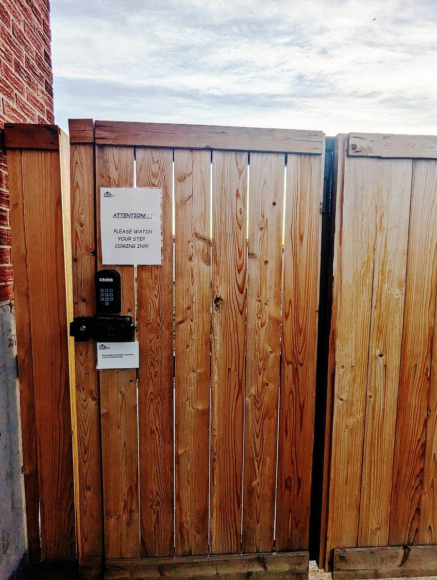 At the end of the driveway is a secured gate to entrance.