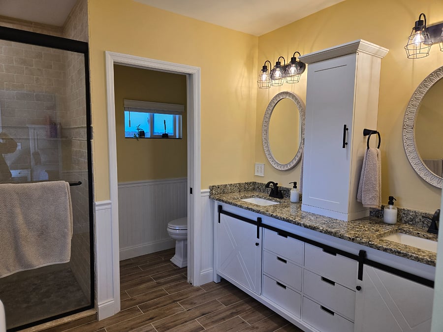 Master bathroom with twin sink vanity and walk-in shower