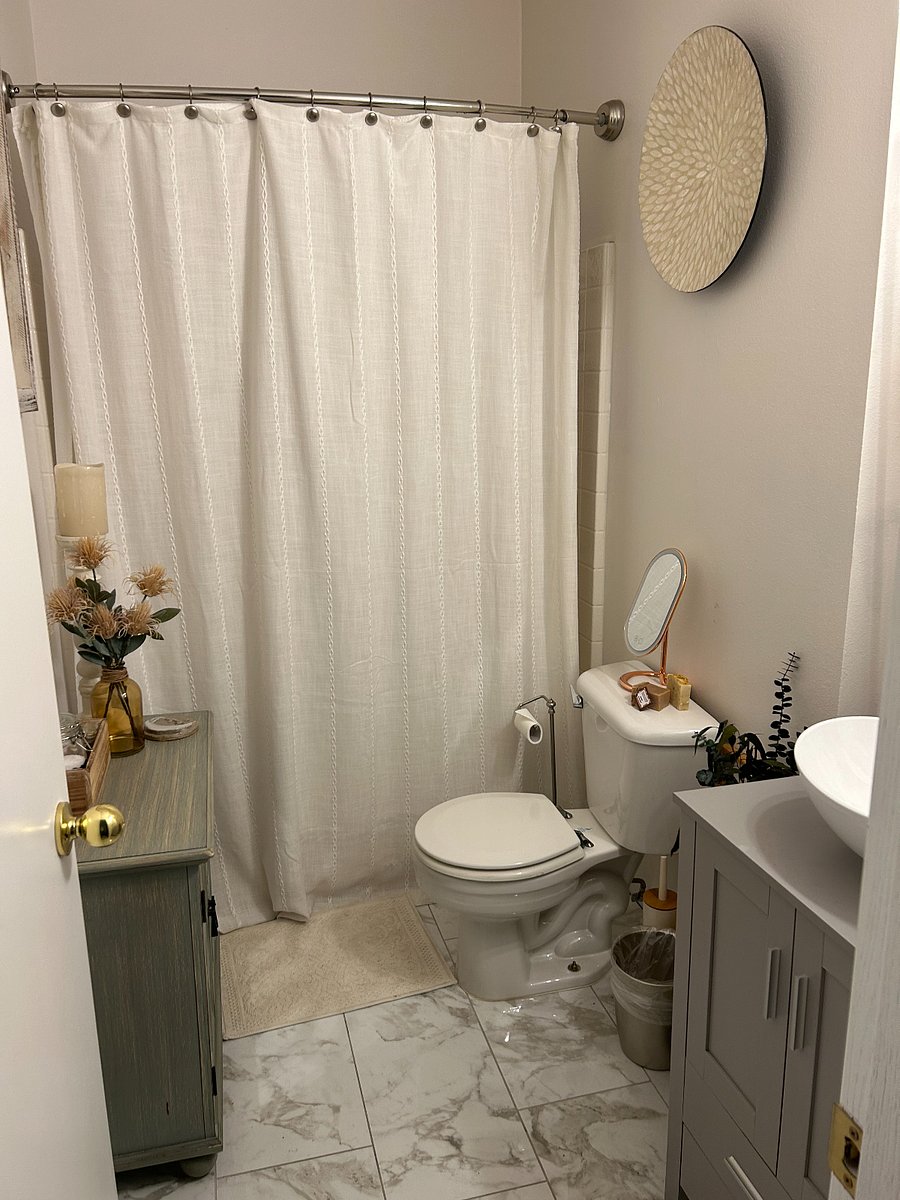 Secondary bathroom with full tub and shower and vessel sink vanity.