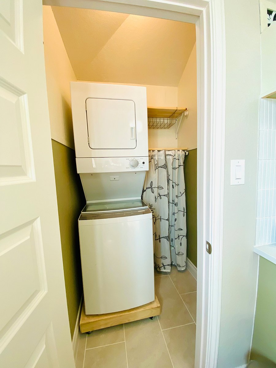 washer dryer tucked in the closet.It has shelves for storage,the curtain hides the mop and floor/carpet vacuum.