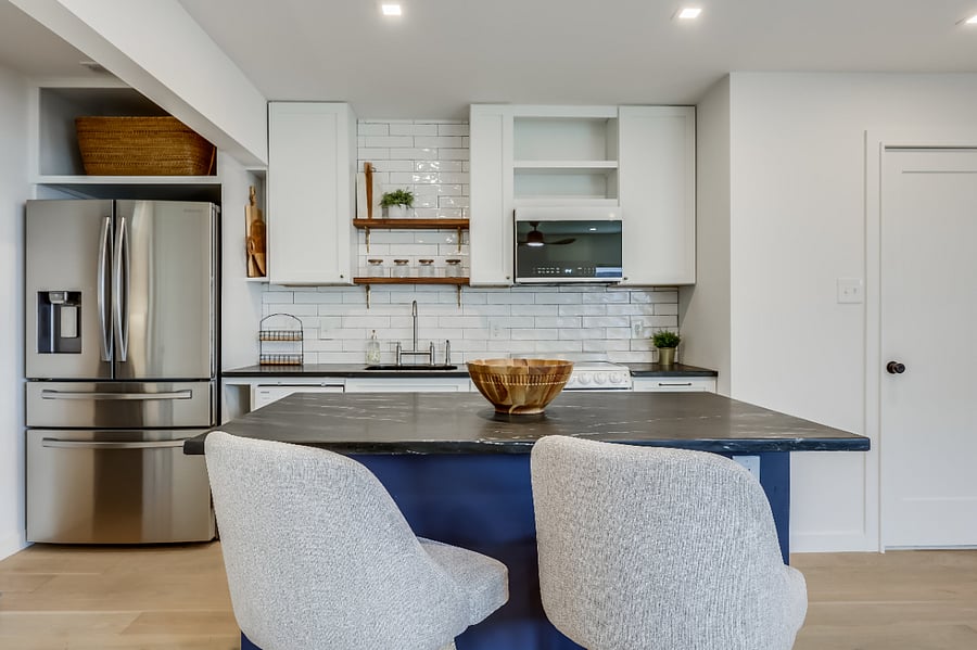 Large kitchen island with ample storage space, room for dining, and outlet with USB-A/C ports.